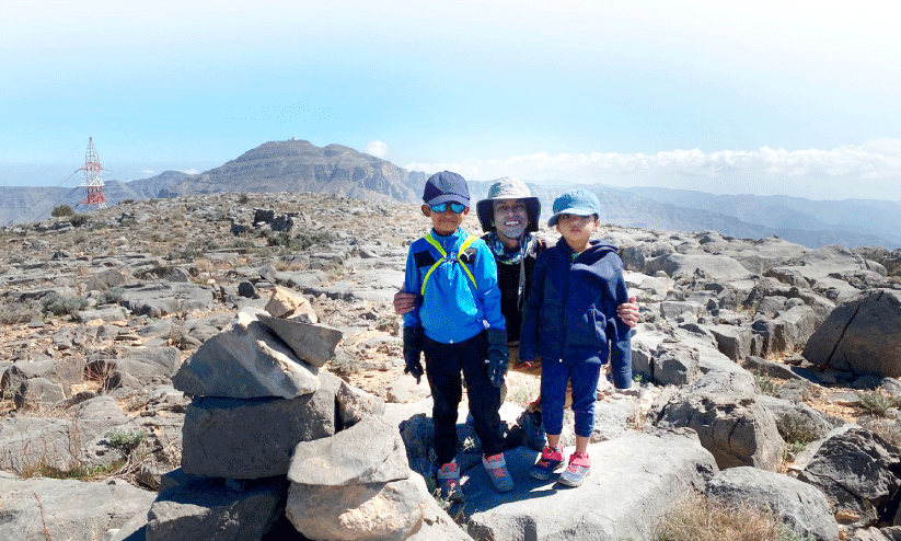 hiking kids aadi shelvan and iya at top of jabal jais