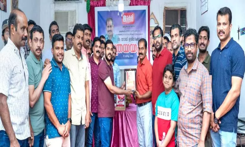 unit members handing a gift to roy