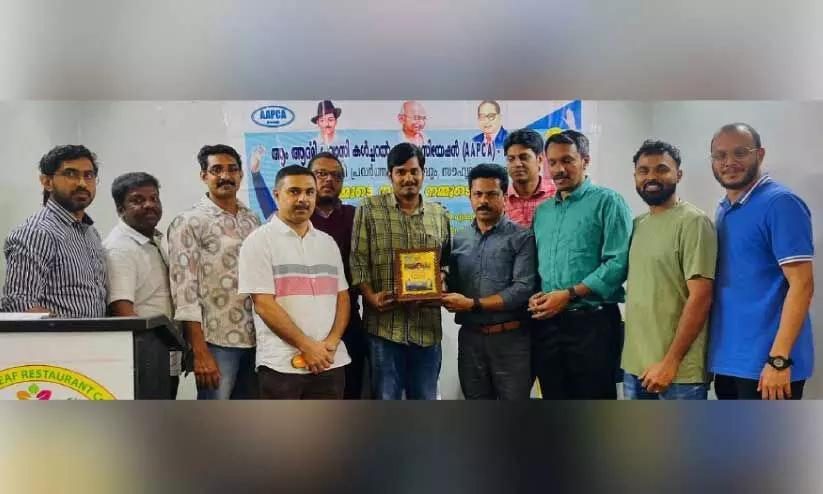 handing a gift to praveen gohn handing a gift to praveen gohn