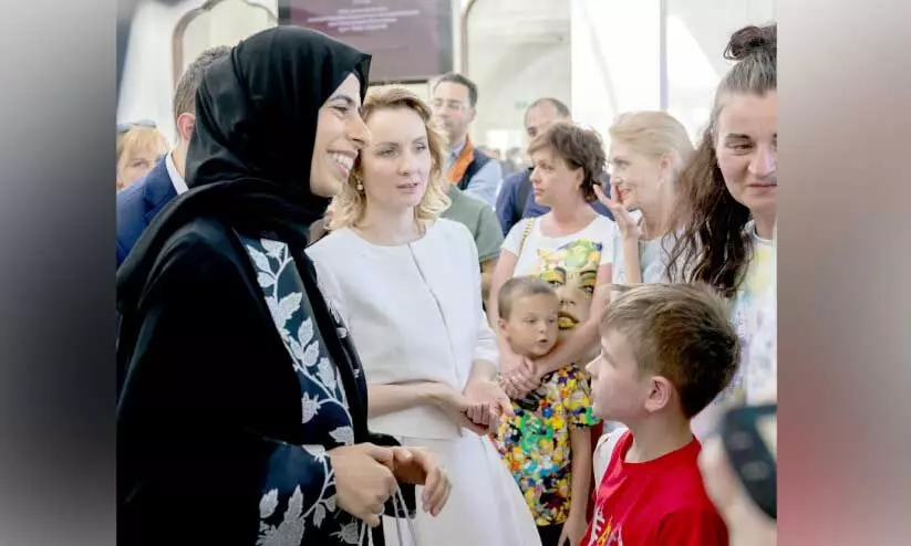 Minister Lulwa Bint Rashid Al Khatir with Ukrain-Russian children