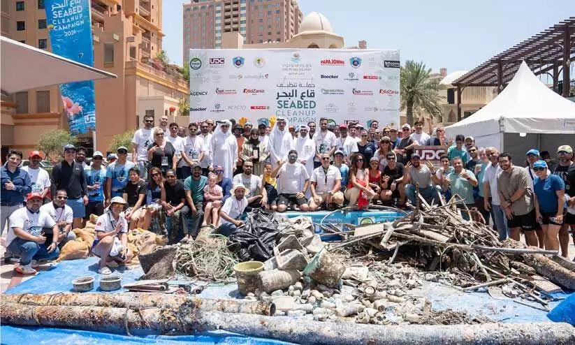 volunteer team with waste removed from beach