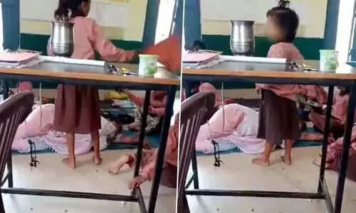 UP primary school teacher caught sleeping suspended
