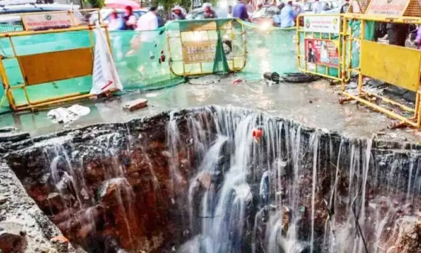 Road damaged due to flooding in Bangalore city Road damaged due to flooding in Bangalore city