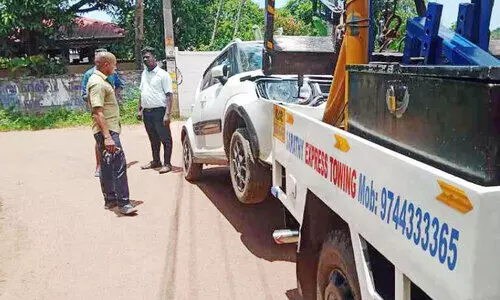 Lifting a fallen car using a crane Lifting a fallen car using a crane