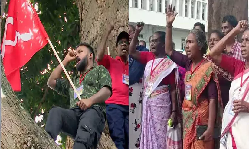 പാർട്ടികൊടിയുമേന്തി മരത്തിൽ കയറി ശുചീകരണ തൊഴിലാളികളുടെ ആത്ഹത്യ ഭീഷണി