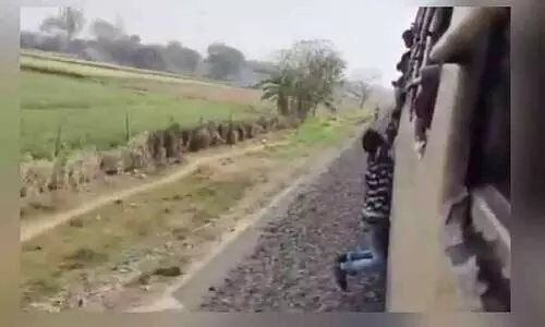 ഓടിക്കൊണ്ടിരുന്ന ട്രെയിനിൽ തൂങ്ങി സാഹസം കാട്ടി യുവാവ്; വൈറലായി വീഡിയോ