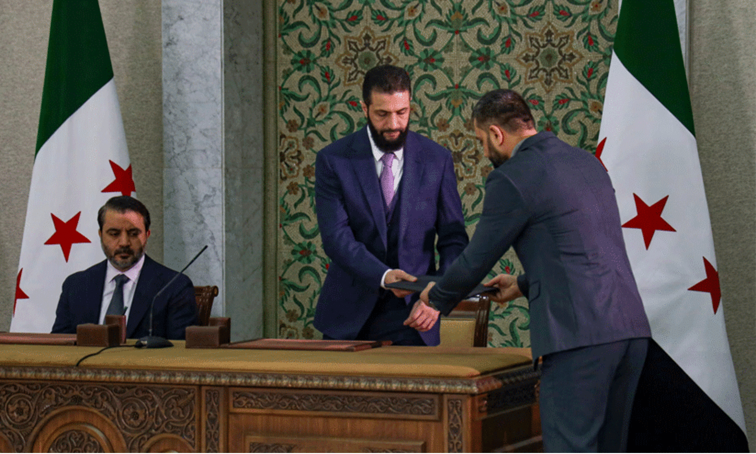 Syria’s leader proclaims new history after signing constitutional declaration