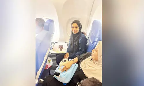 Haya Fuhad with a cake presented by the cabin crew on the flight Haya Fuhad with a cake presented by the cabin crew on the flight