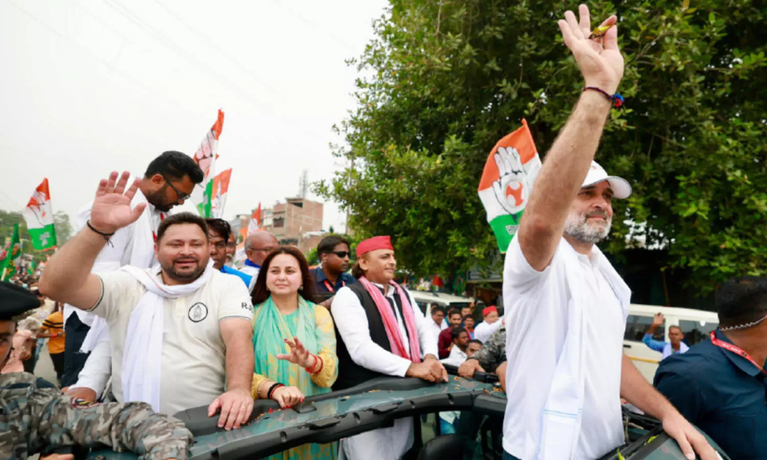 Akhilesh Yadav and Tejashwi Yadav stand behind Rahul Gandhi during the voter registration drive in Saran, Bihar.