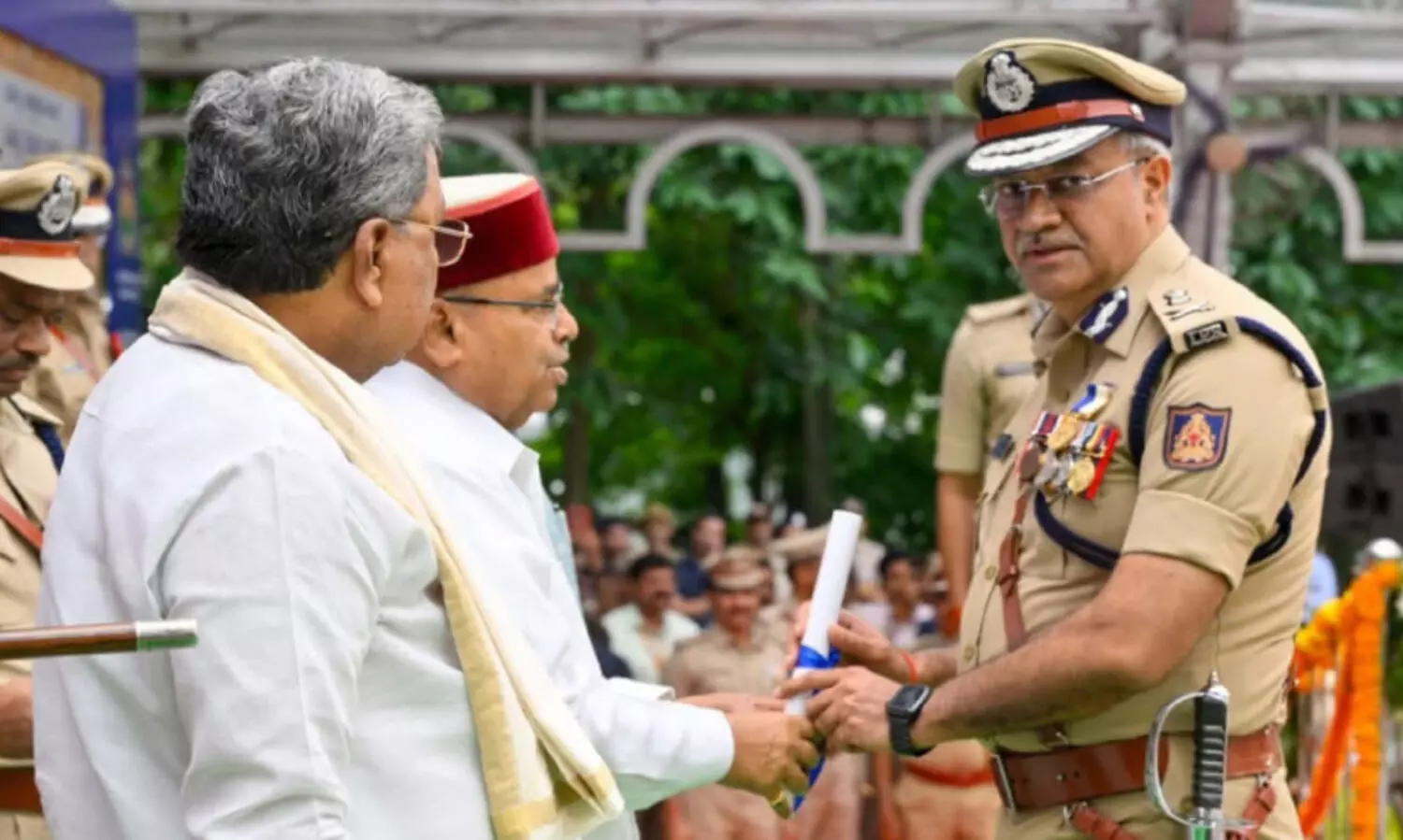 Governor Thawar Chand Gehlot presents the medal, Chief Minister Siddaramaiah is present.