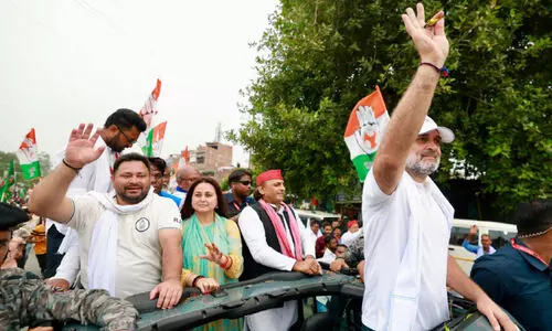 Akhilesh Yadav and Tejashwi Yadav stand behind Rahul Gandhi during the voter registration drive in Saran, Bihar.