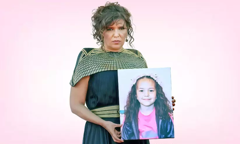 Kahoutar Ben Haniya with a picture of Hind Rajab Kahoutar Ben Haniya with a picture of Hind Rajab