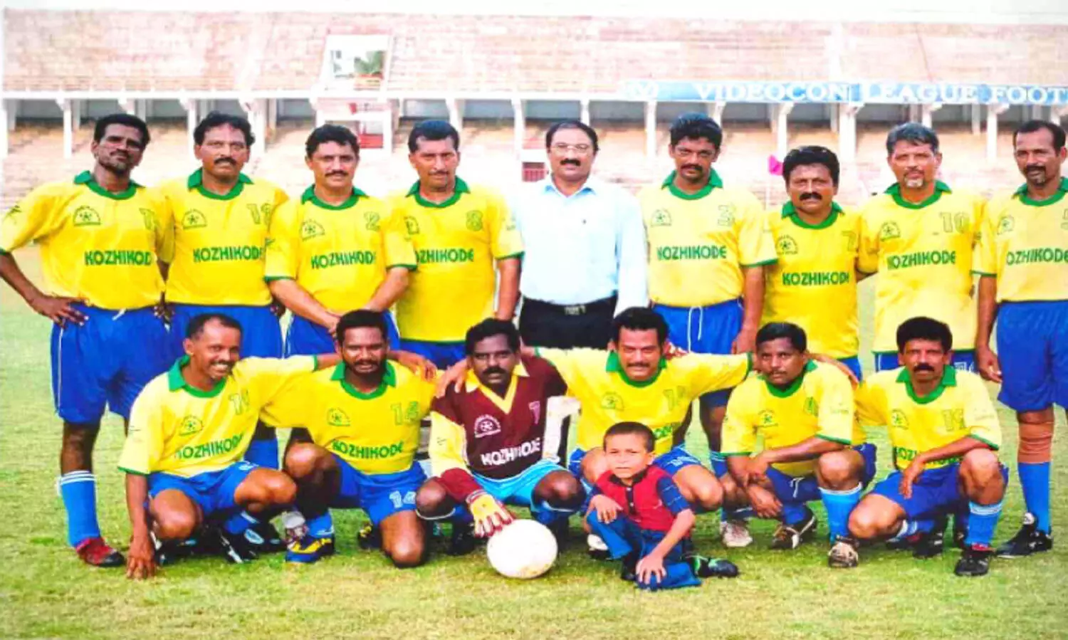 Chandran (standing, far left) wearing a jersey on the field