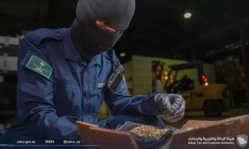 Customs officer inspecting seized drugs