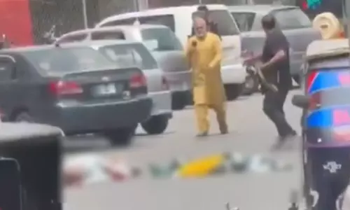 Bodies of those killed by Pakistani security forces lie on the road in Pakistan-occupied Kashmir