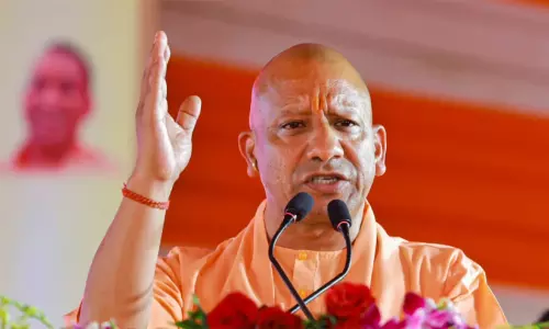 Uttar Pradesh Chief Minister Yogi Adityanath addressing an event, representing human rights scrutiny and international sanctions petition