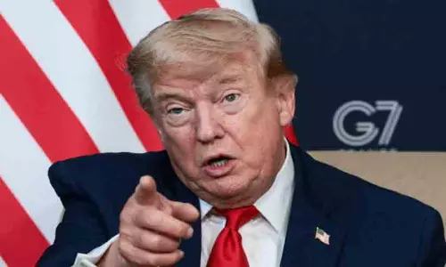 US President Donald Trump gesturing during a press briefing in the Oval Office