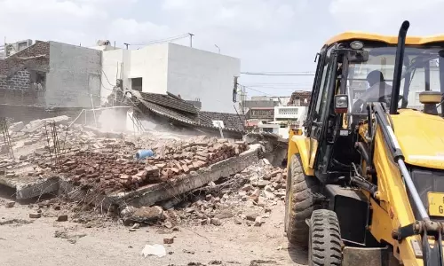 Bulldozers razing commercial shops during demolition drives in Gujarat Bulldozers razing commercial shops during demolition drives in Gujarat