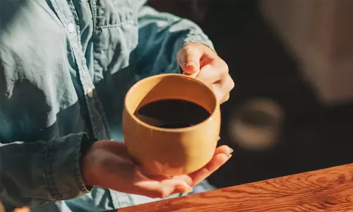 A cup of black coffee highlighting health benefits for liver protection and medical advice.