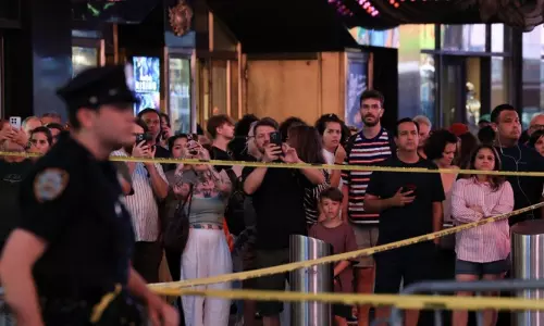 NYPD officers cordoning off Times Square crime scene after the stabbing incident.