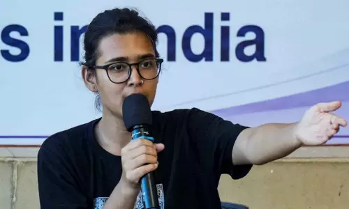 AISA national president and student activist Neha Bora addressing a political gathering AISA national president and student activist Neha Bora addressing a political gathering