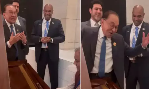 Malaysian Prime Minister Anwar Ibrahim singing a classic Hindi song with a musical troupe in New Delhi.