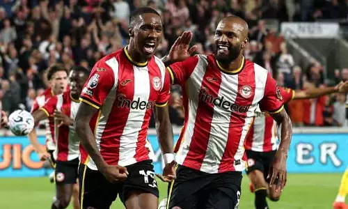 Brentford players celebrating a goal against Chelsea in the Premier League