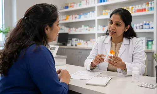 A clinical pharmacist counseling a patient at the pharmacy counter about safe medication dosage and timing.