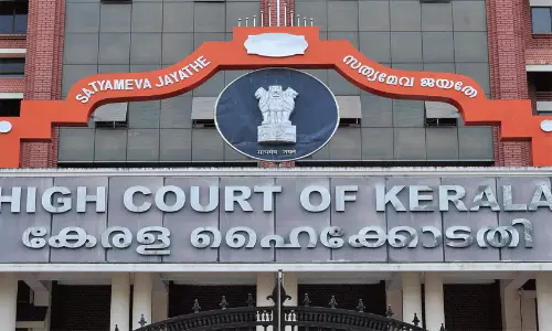 The Kerala High Court building facade in Kochi with surrounding premises.