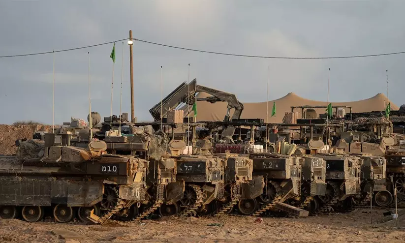 Israeli military outpost area in northern Gaza with military vehicles operating in the background Israeli military outpost area in northern Gaza with military vehicles operating in the background