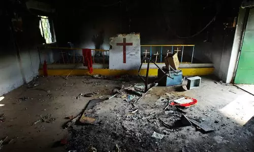 A vandalised house church entrance with religious markings following an attack in West Bengal.