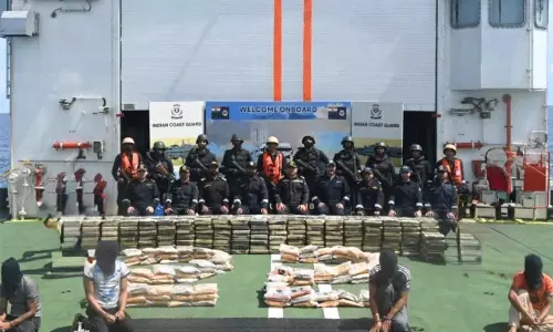 Indian Coast Guard ship and seized boat carrying illegal narcotics in the Arabian Sea