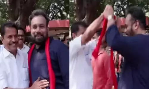 MP John Brittas offering a red shawl to Adoor Prakash during the opposition protest march in New Delhi MP John Brittas offering a red shawl to Adoor Prakash during the opposition protest march in New Delhi