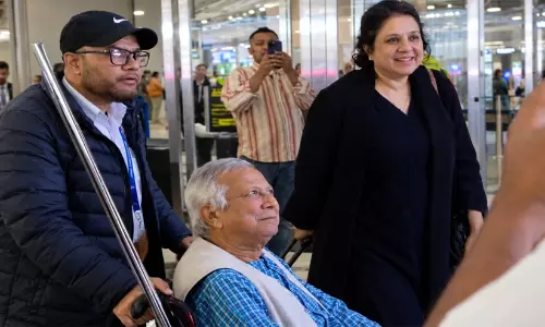 Former Bangladesh interim chief adviser Muhammad Yunus being escorted through New York JFK airport amid protests.