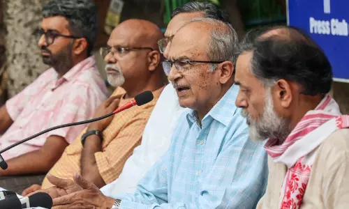Senior advocate Prashant Bhushan addressing a press conference in New Delhi alongside CJP leaders.