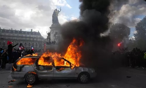 Riot police using tear gas and water cannons against demonstrators on the streets of Paris during the nationwide protest march.