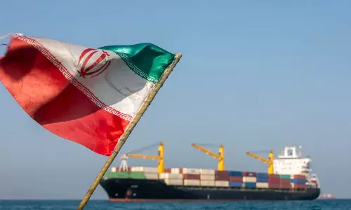 Oil tanker sailing through the Strait of Hormuz amid diplomatic negotiations between the US and Iran.